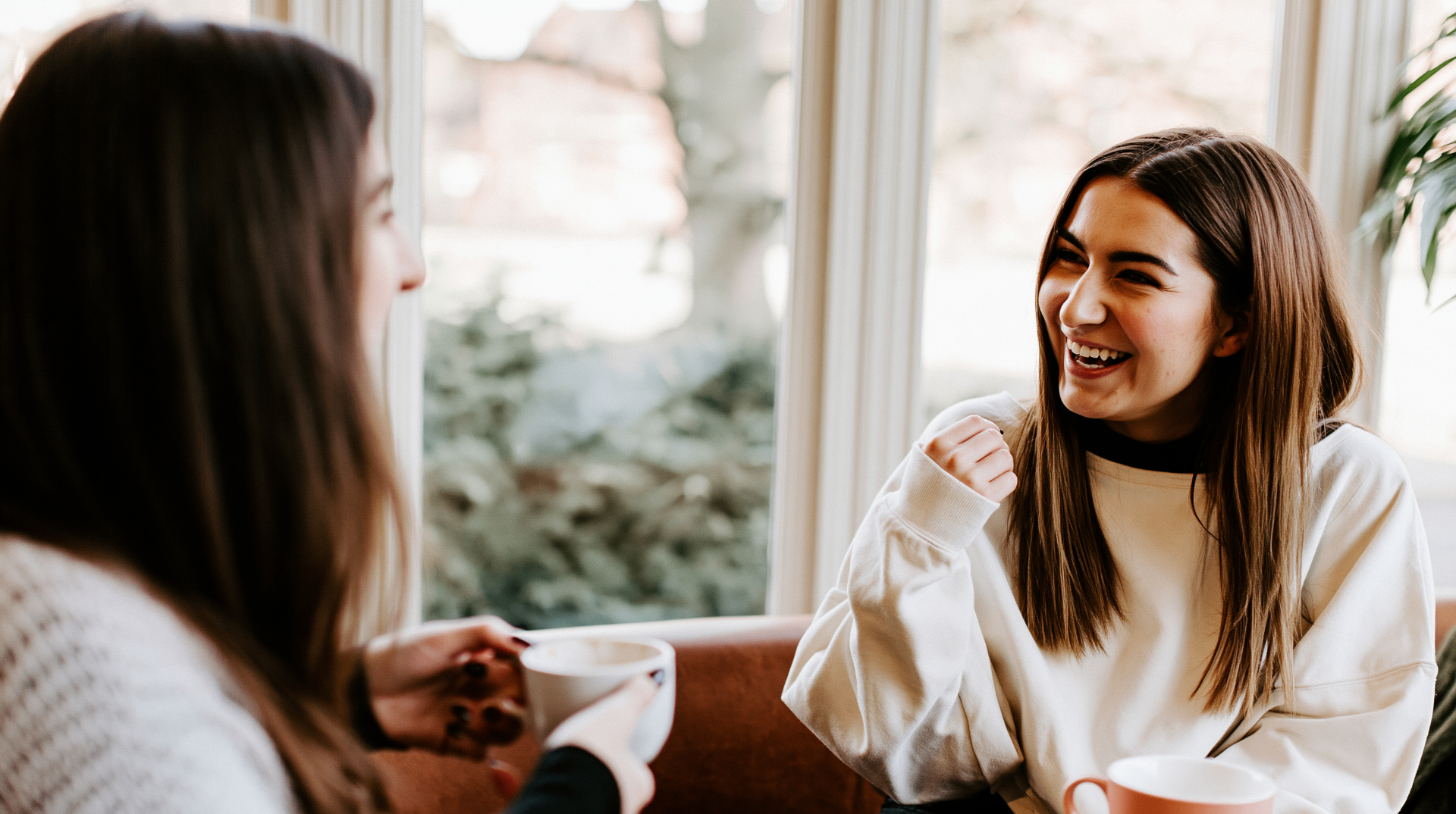Two friends chatting over coffee